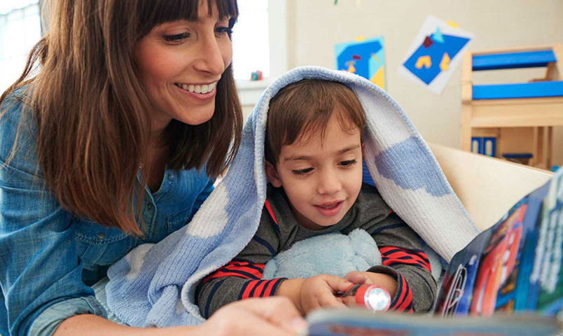 Mom and son reading about potty training