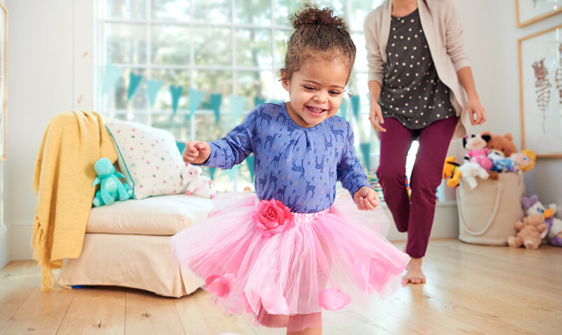 Mom playing chase with daughter to make potty training a fun game