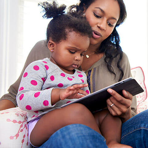 Parents read to child to calm her down before bedtime